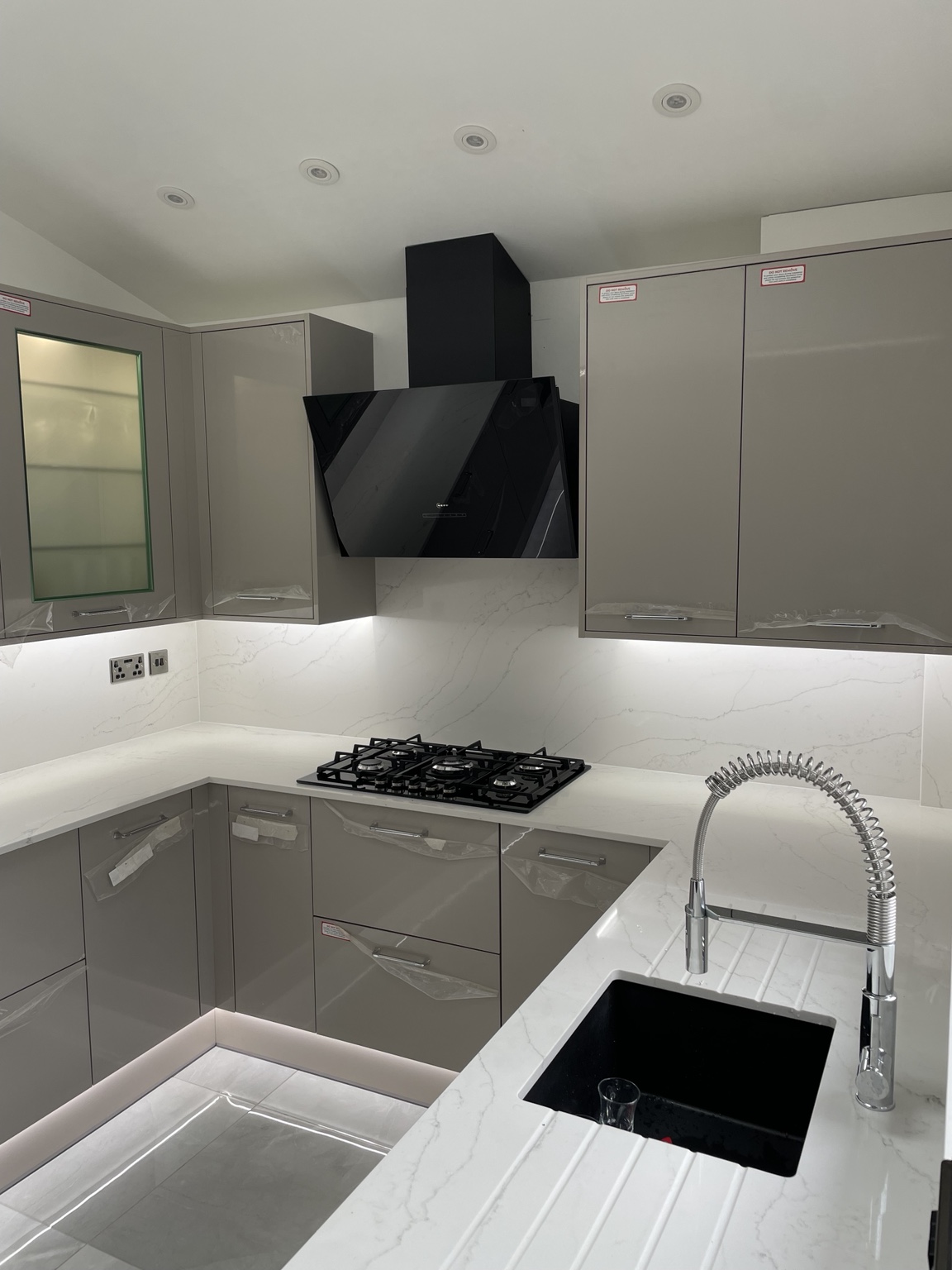 Kitchen installation with hob and lighting